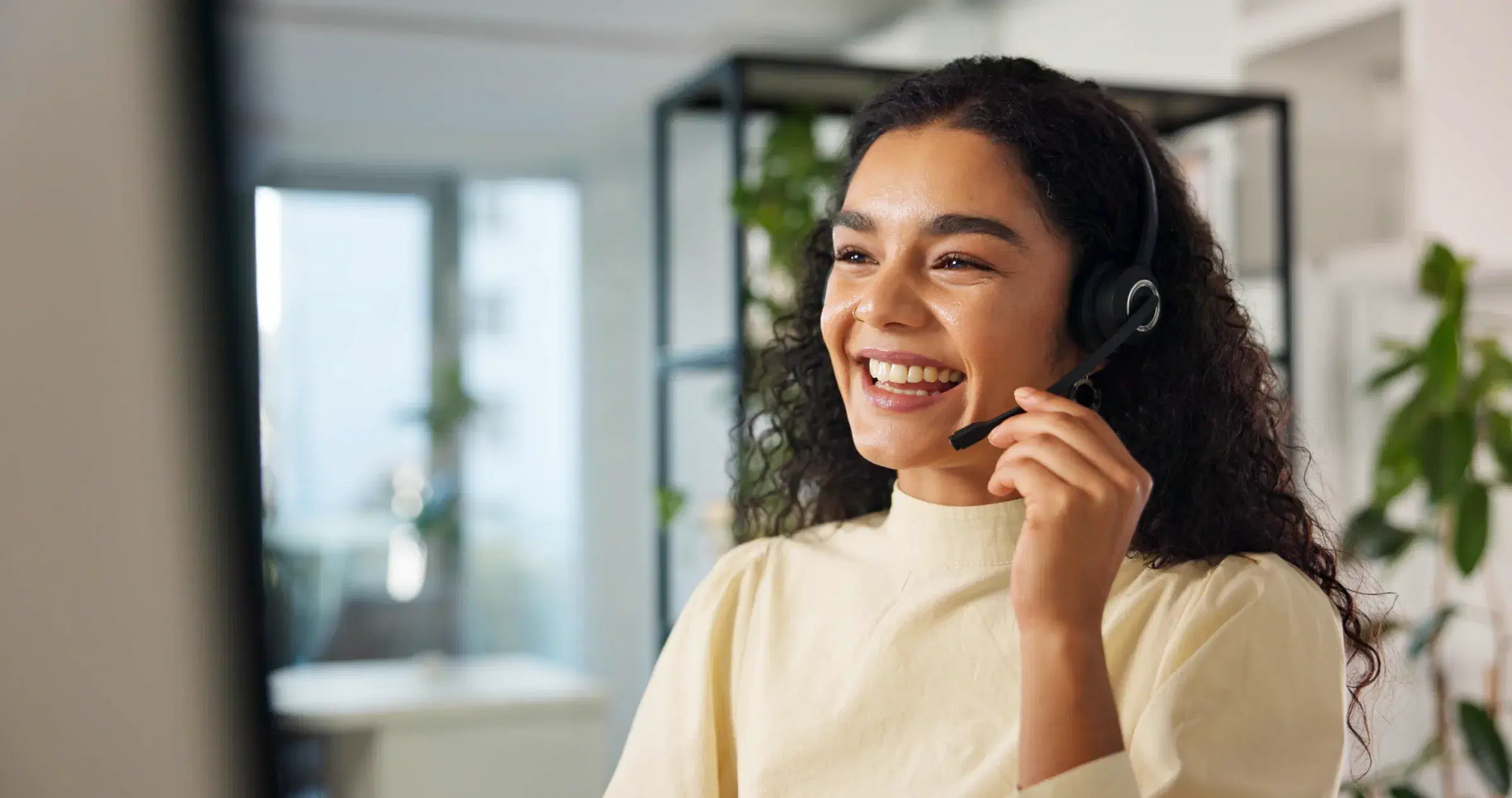 A member of the enquiries team on a headset, mid-conversation.